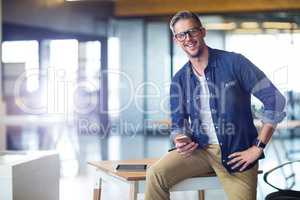 Portrait of man using mobile phone in office