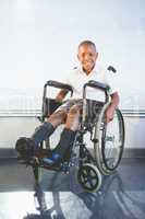 Portrait of schoolkid sitting on wheelchair