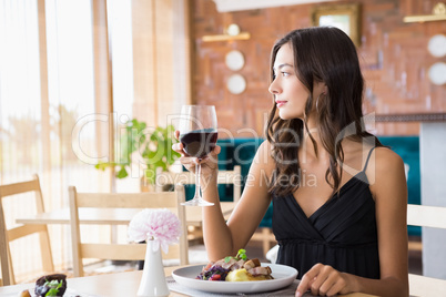 Beautiful woman having wine with meal