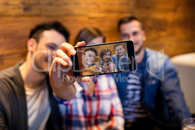 Friends taking selfie at restaurant