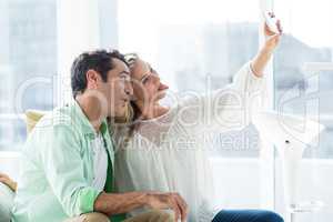Happy couple making face while taking selfie
