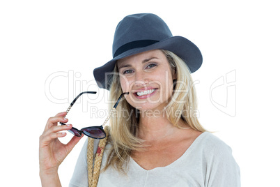 Portrait of mid adult woman holding sunglasses