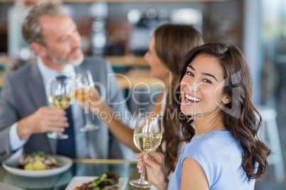 Portrait of beautiful woman holding glass of wine