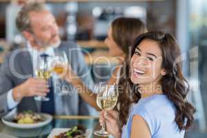 Portrait of beautiful woman holding glass of wine