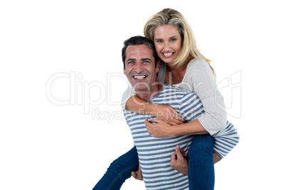 Mid adult man carrying woman piggyback