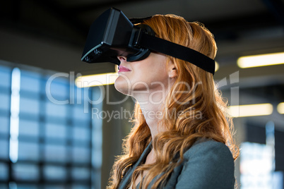 Young businesswoman using virtual reality simulator