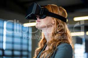 Young businesswoman using virtual reality simulator