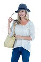 Happy mid adult woman holding sunglasses