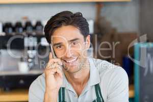 Portrait of waiter talking on mobile phone