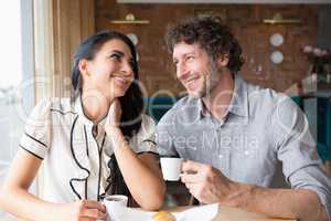 Couple having coffee in cafeteria