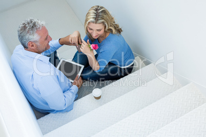 High angle view of man giving rose to woman