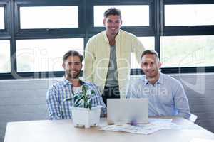 Smart creative businessmen by table