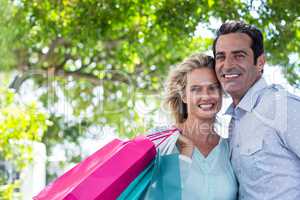 Portrait of couple with shopping bags