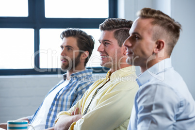 Confident businessmen sitting in creative office