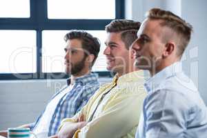 Confident businessmen sitting in creative office