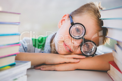 Close-up of schoolkid leaning on desk in classroom