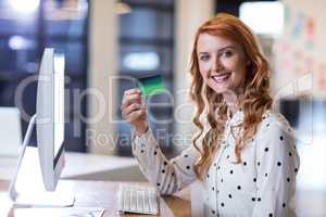 Businesswoman holding smart card in office