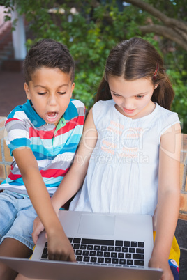 Schoolkids using laptop in school campus