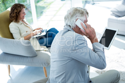 Man by woman talking on cellphone