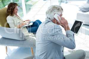 Man by woman talking on cellphone