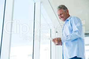 Low angle view of smiling man using phone