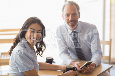 Business colleagues smiling while having tea