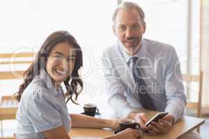 Business colleagues smiling while having tea