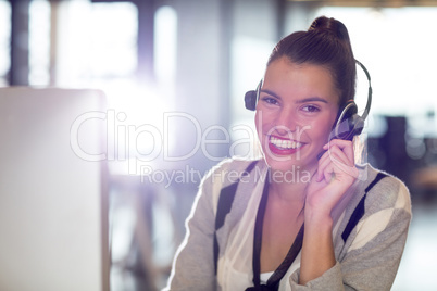 Portrait of woman with headphones in office Portrait of woman with headphones in office