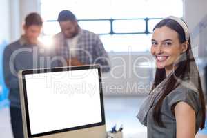 Happy businesswoman while colleagues in background