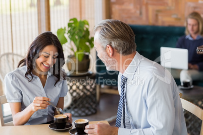 Man and woman meeting over coffee in restaurant