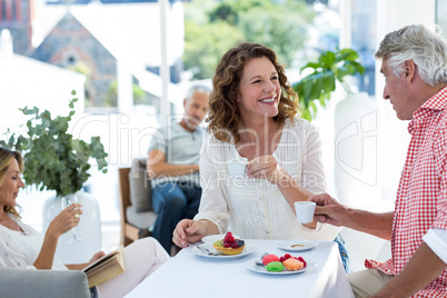 Mature couple smiling while having coffee