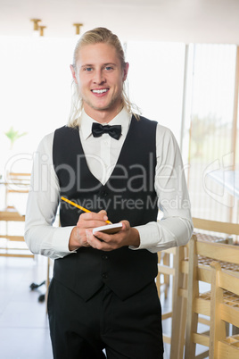 Waiter writing order on notepad