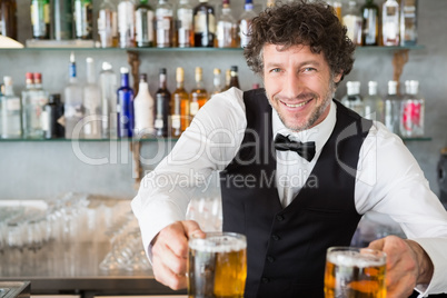 Waiter serving mug of beers