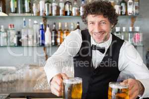 Waiter serving mug of beers