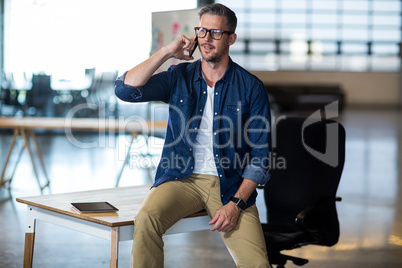 Man talking on phone in office