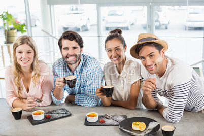 Group of happy friends having cup of coffee