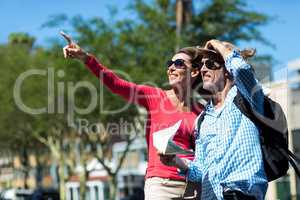Mature couple standing at street on sunny day