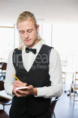 Waiter writing order on notepad