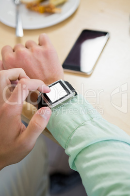 Man adjusting time on his smartwatch