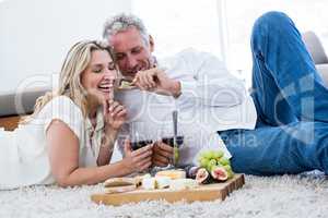 Romantic man feeding woman