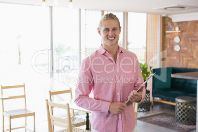 Restaurant manager holding clipboard