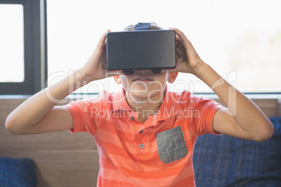 School kid using virtual reality glasses in library