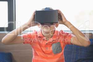 School kid using virtual reality glasses in library