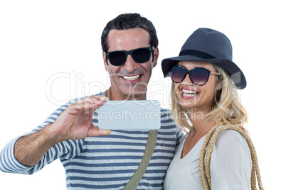 Mid adult couple smiling while taking selfie