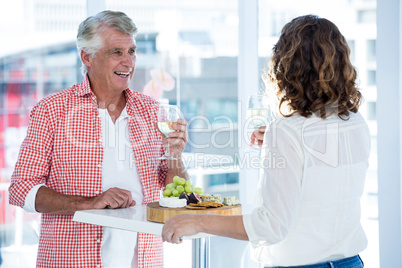 Mature man with woman holding champagne glass