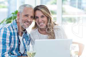 Mature couple sitting by table in restaurant