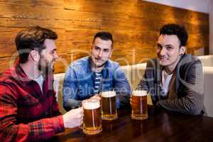 Young friends enjoying beer at restaurant