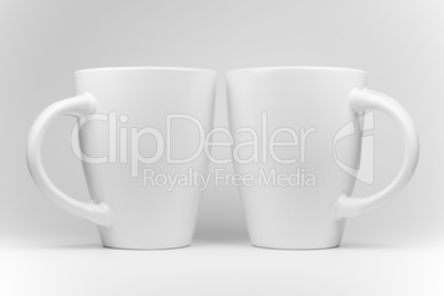 Two white mugs in a mirrored arrangement .