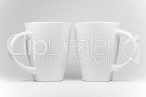 Two white mugs in a mirrored arrangement .