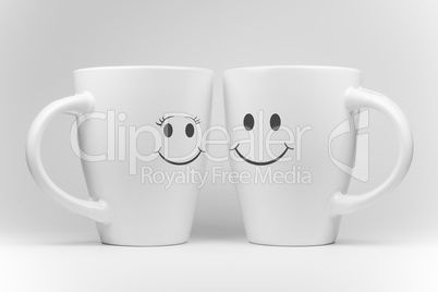 Two white mugs with facial expressions.